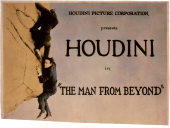 Escapologist-turned-actor Harry Houdini and unidentified man in a
                cliffhanging scene.