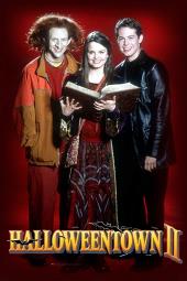 Kimberley Brown (as Marnie Piper), Phillip Van Kyke (as Luke the Goblin), and
              Daniel Kountz (as Kal) pose around an open book of spells.