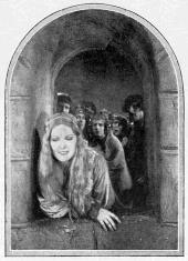 Long-haired Mirian Seegar (as Lady Rowena) leans out a castle window.