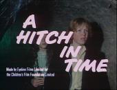 Children Michael McVey (as Paul Gibson) and Pheona McLelian (as Fiona
                Hatton-Jones) in a cave beind the Title card from A Hitch in Time.