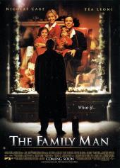 On a snowy night, Nicolas Cage (as Jack Campbell) stares at a store window
              display of himself with a family.