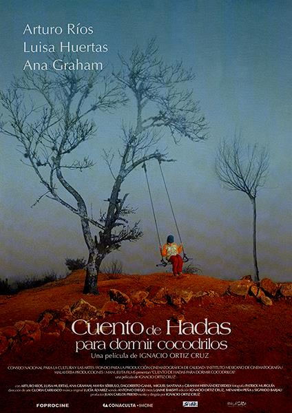 A child on a swing, ahnging from a leafless tree on barren red earth.
