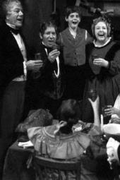 Cyril Ritchard (as Scrooge), Alfie Bass (as Bob Cratchett), Neil Culleton (as
              Tiny Tm), and Tessie O’Shea (as Mrs. Cratchett) sing and raise a toast.