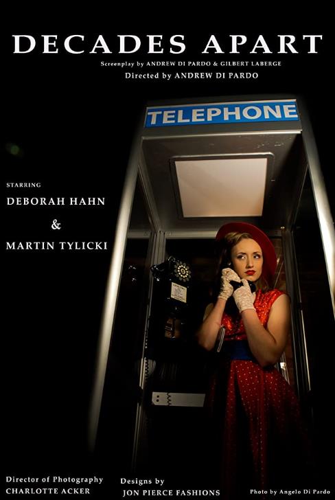 Dressed in a red hat and polka dot dress, Deboarah Hahn (as Diane) talks on a 1950s phone in a booth.