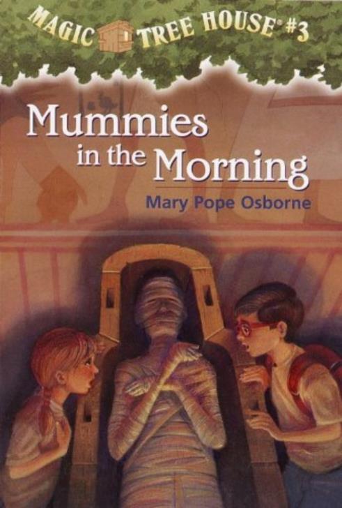 Young Jack and his younger sister Annie gasp at a mummie in an open coffin.