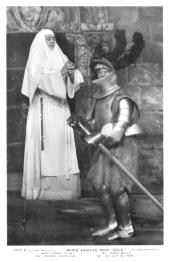 A puzzled James Welch (as Sir Guy, dressed in a full suit of armor) stands in
              front of a praying Audrey Ford (as Revena Eggington, in a white nun’s habit).