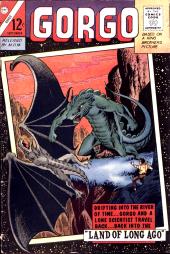 A giant green reptile bats at a dark pterodactyl while a man cowers to one
                side.