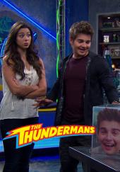 Kira Kosarin (as Phoebe) looks on disbelievingly at Jack Griffo (as Max)
                grinning evilly at a transparent cube that displays a picture of his own head.