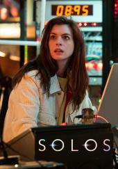A startled Anne Hathaway (as physicist Leah Salavara) looks up from her
                computer in a lab packed with electronics and futuristic screens.