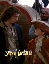 On a pirate ship in pirate drab, John Ales (as the Genie) and Nathan Lawrence
                (as Travis) stare each other down.