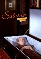 Melissa Joan Hart (as Sabrina) lies peacefully in a white-lined coffin.