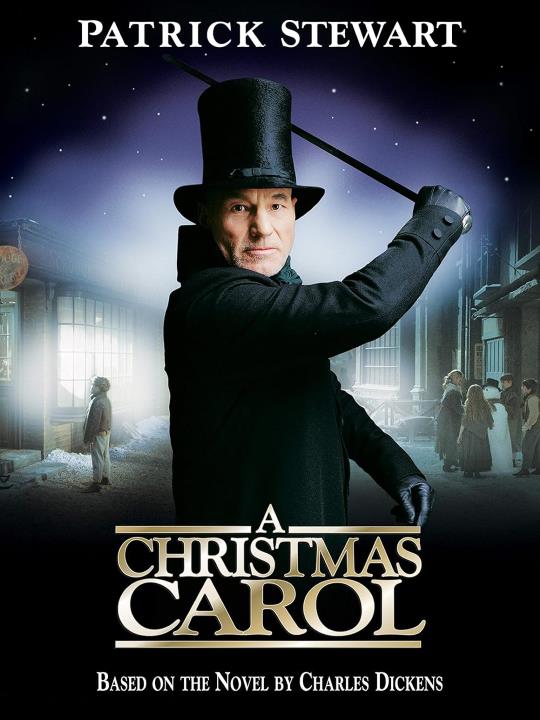 Dressed in a black Victorian tophat, black coat, and black gloves, Patrick Stewart (as Scrooge) raises his cane as if to strike.